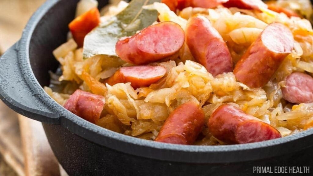 Cast iron bowl with cabbage and sausage.