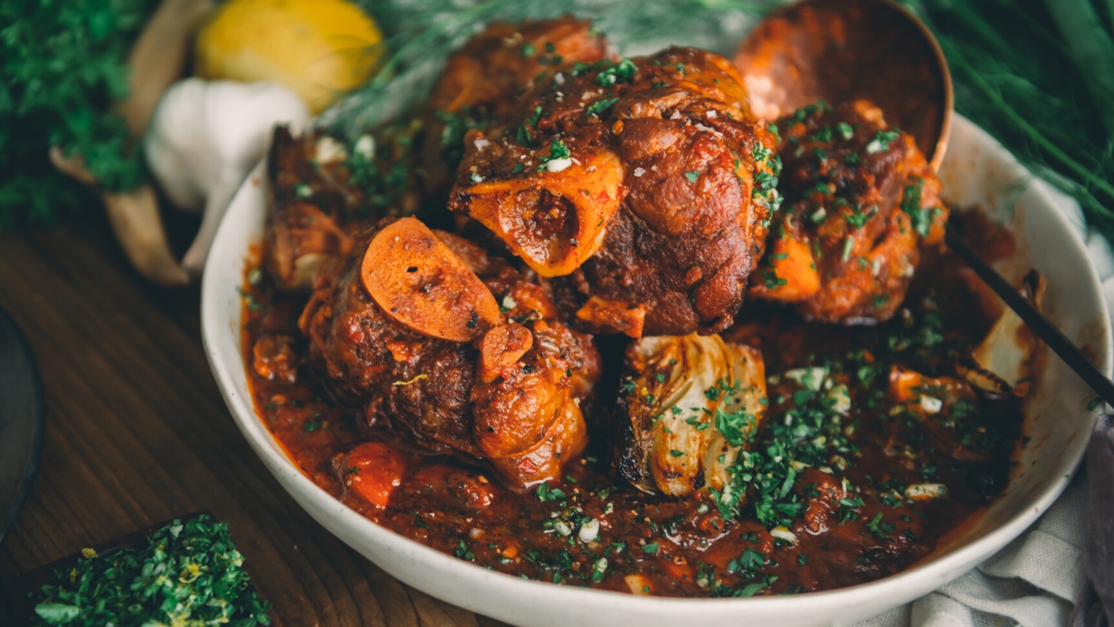 Sous vide pork shank osso buco plated with sauce.