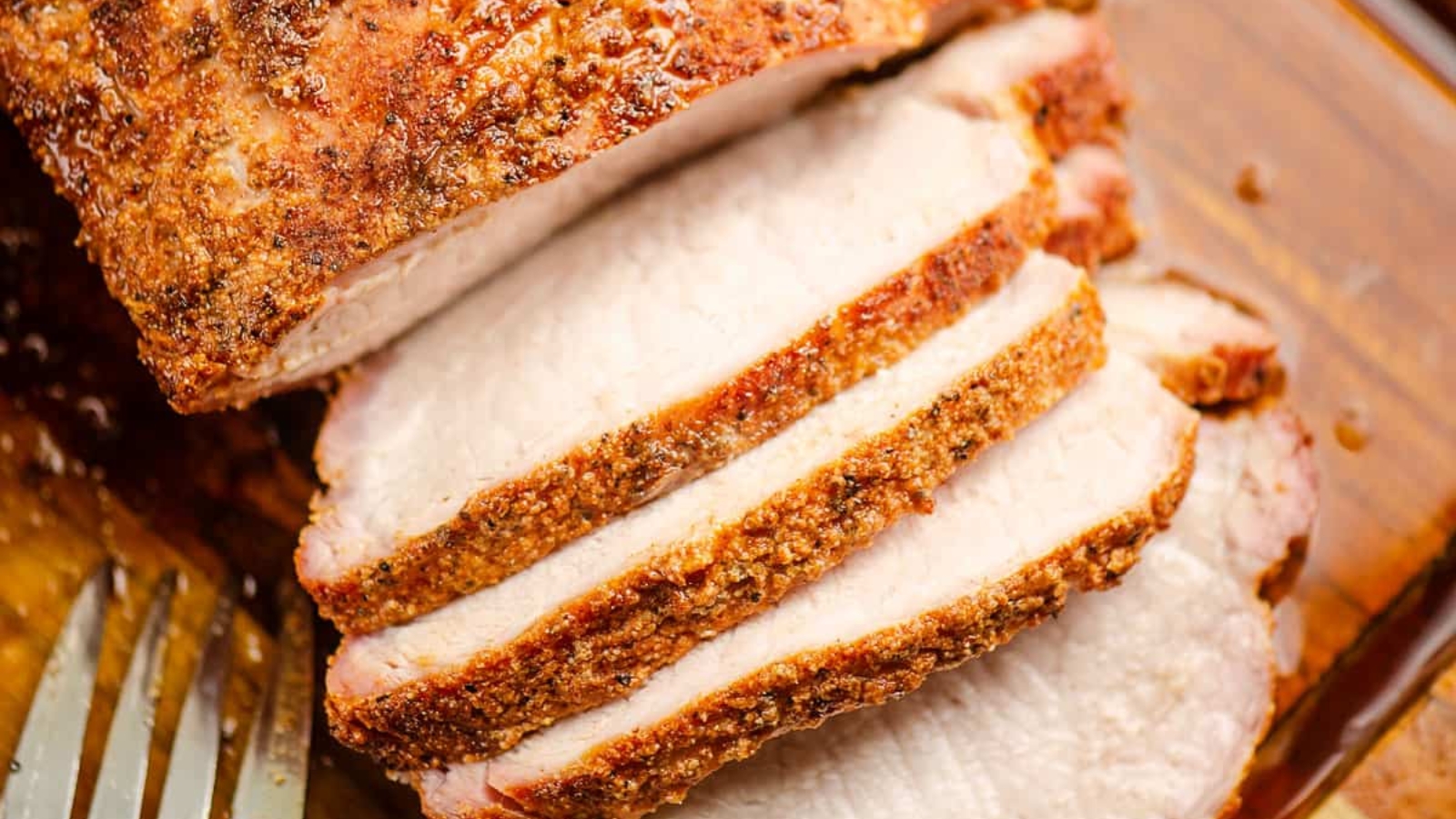 Smoked pork loin roast sliced and served on a board.