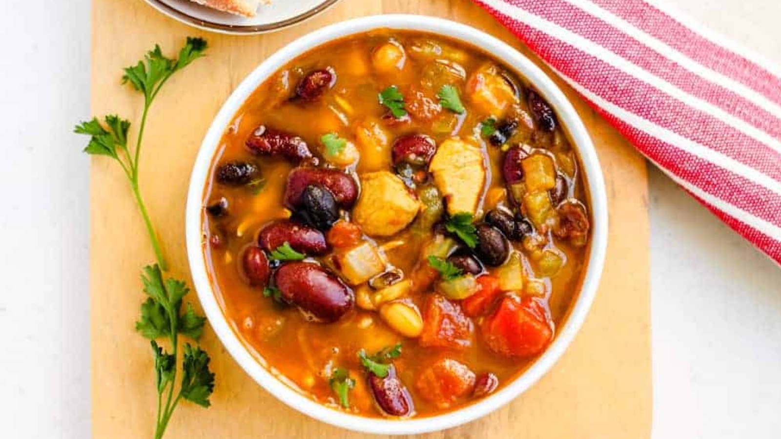Overhead image of a bowl of chicken bean soup.