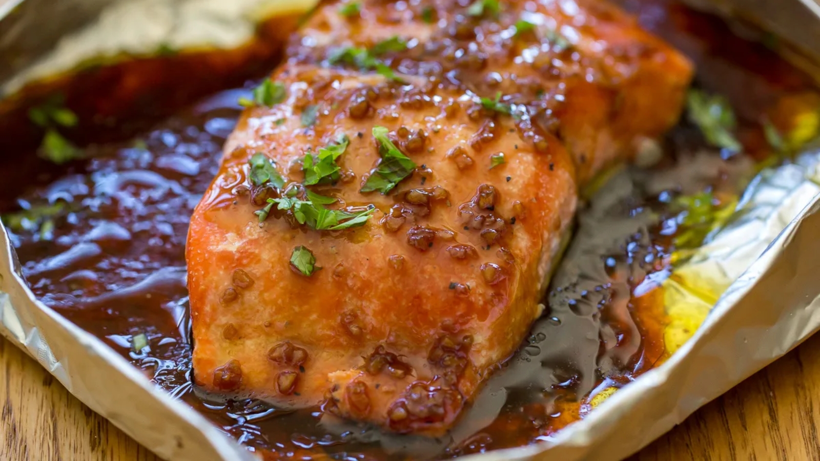 Traeger honey garlic salmon fillet glazed with a glossy sauce and cooked on a wood pellet grill.
