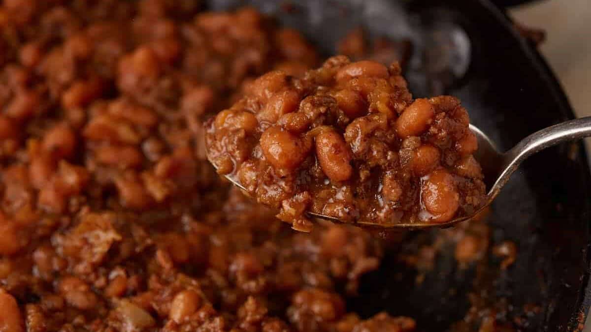 Beans bake slowly in a thickening sauce until evenly coated and set.