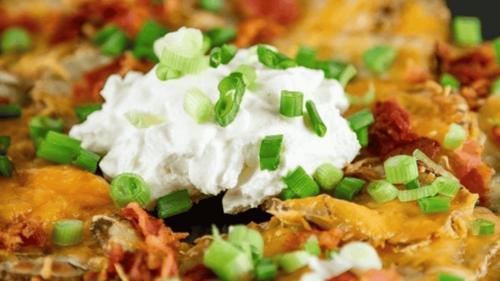 Irish nachos with crispy potato rounds, melted cheese, bacon, and green onions.