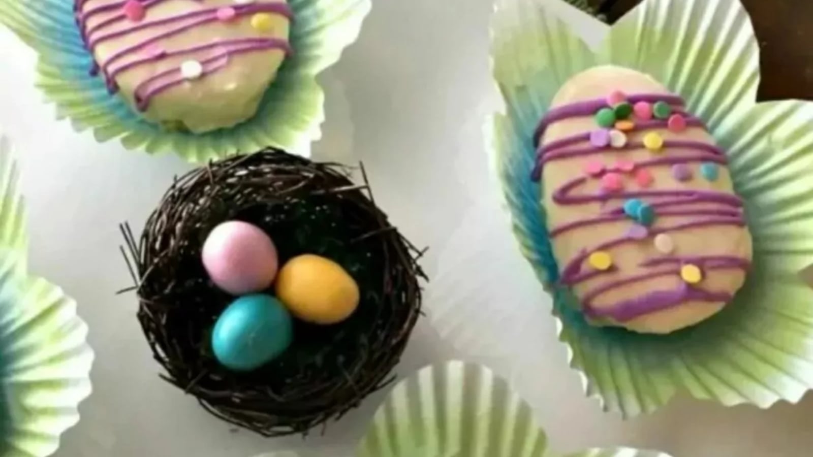 Mini Easter egg cakes decorated with pastel colors.