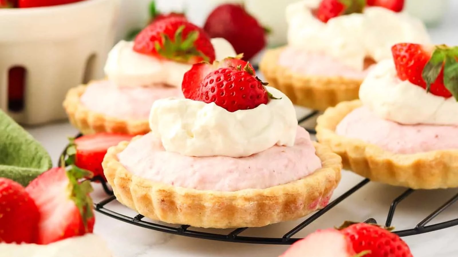 Strawberry mousse tartlets with a smooth pink filling.